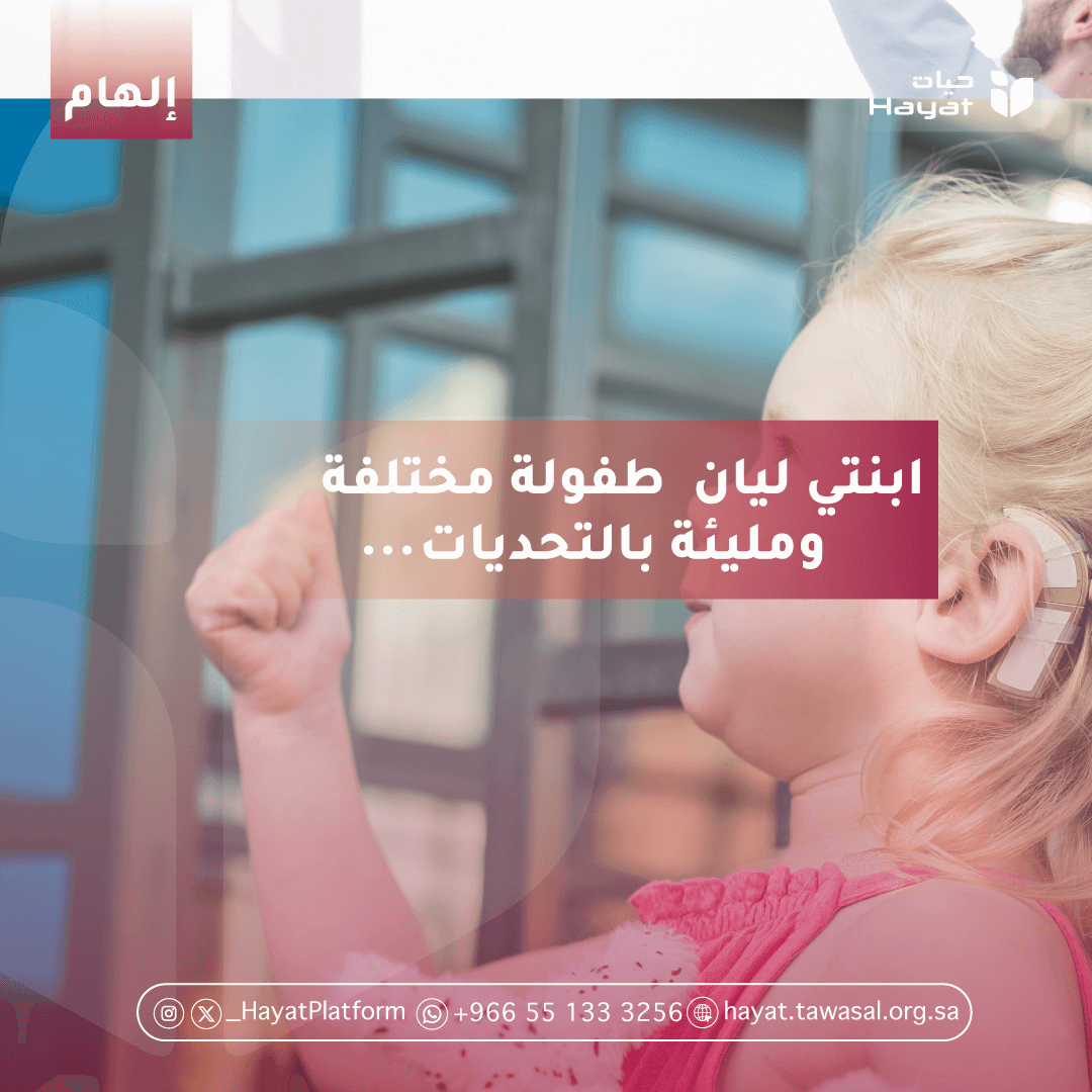 طفلة صغيرة شقراء ترتدي جهازًا مساعدًا للسمع، تظهر وهي ترفع يدها بابتسامة